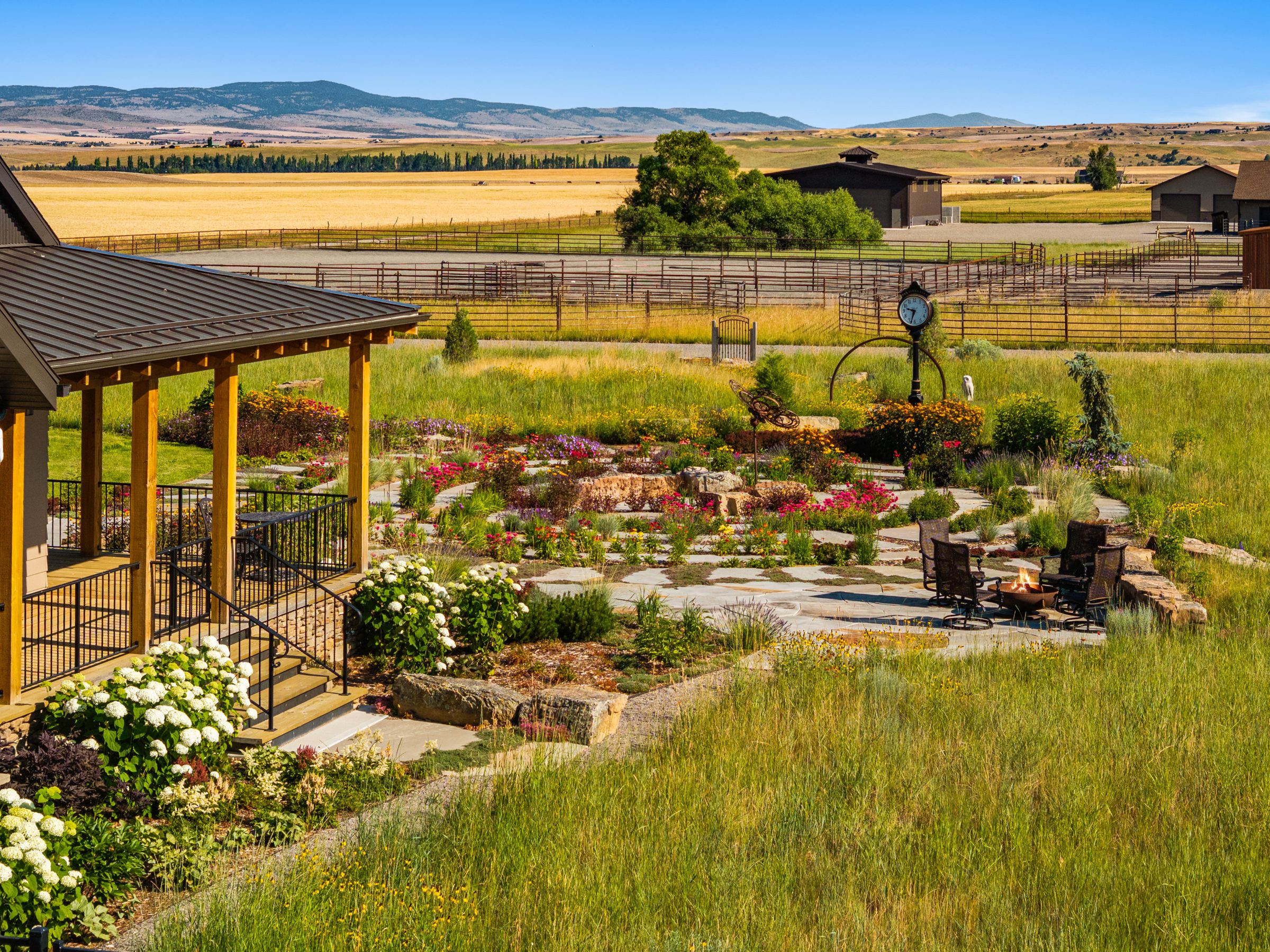 Landscaped backyard garden with patio and fire pit