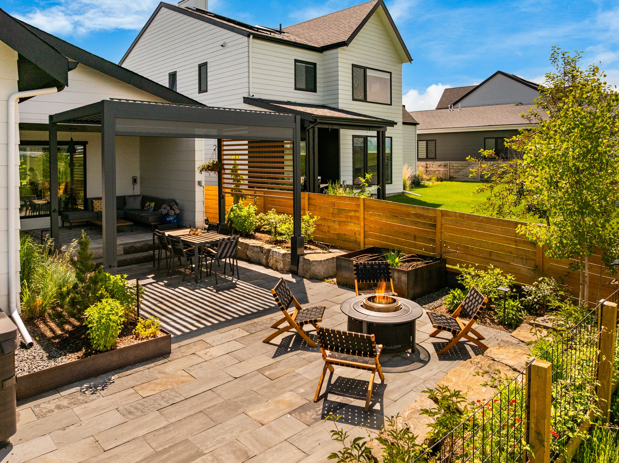 Modern backyard patio with pergola and fire pit