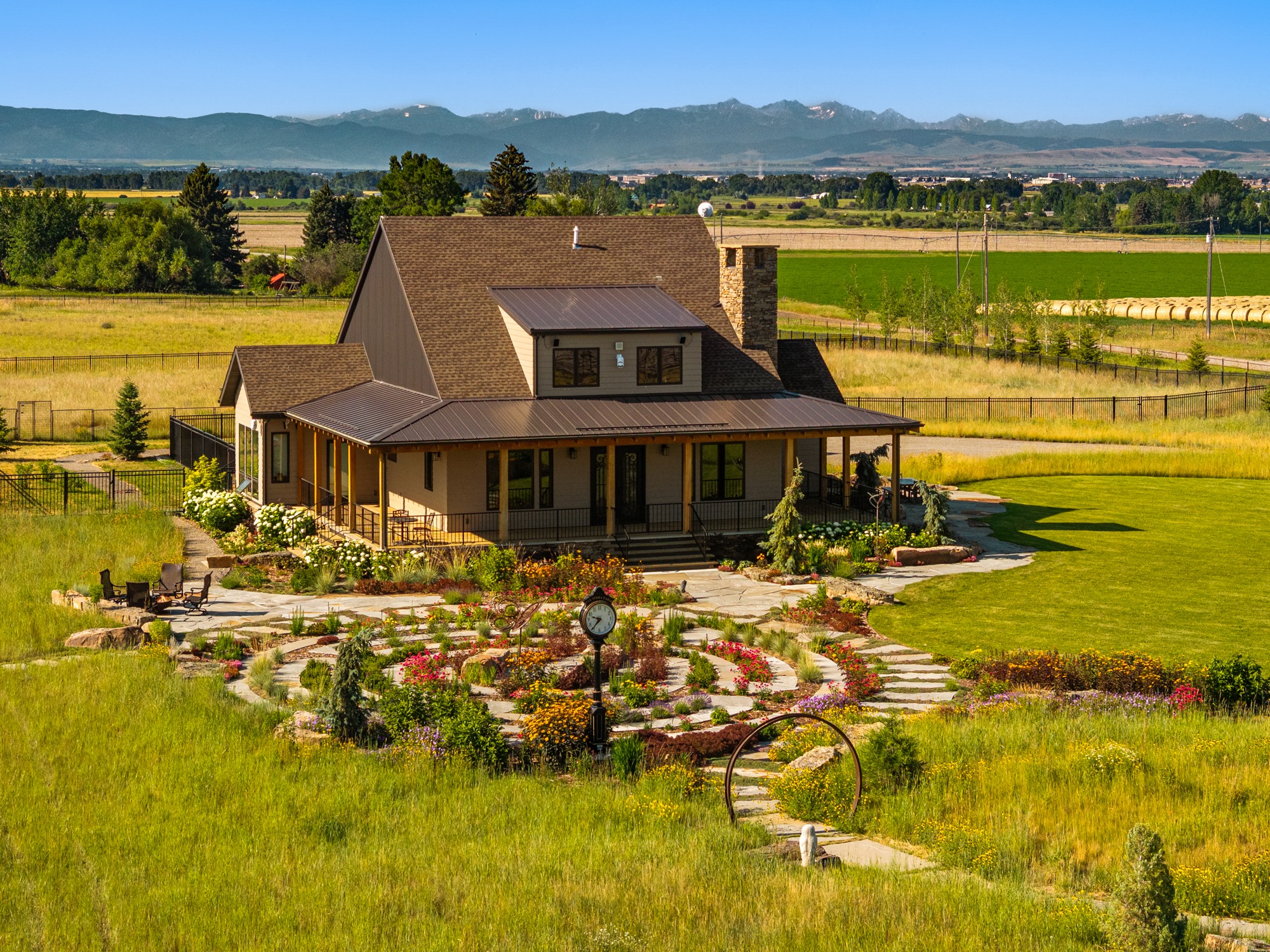Rural farmhouse with garden and mountain backdrop