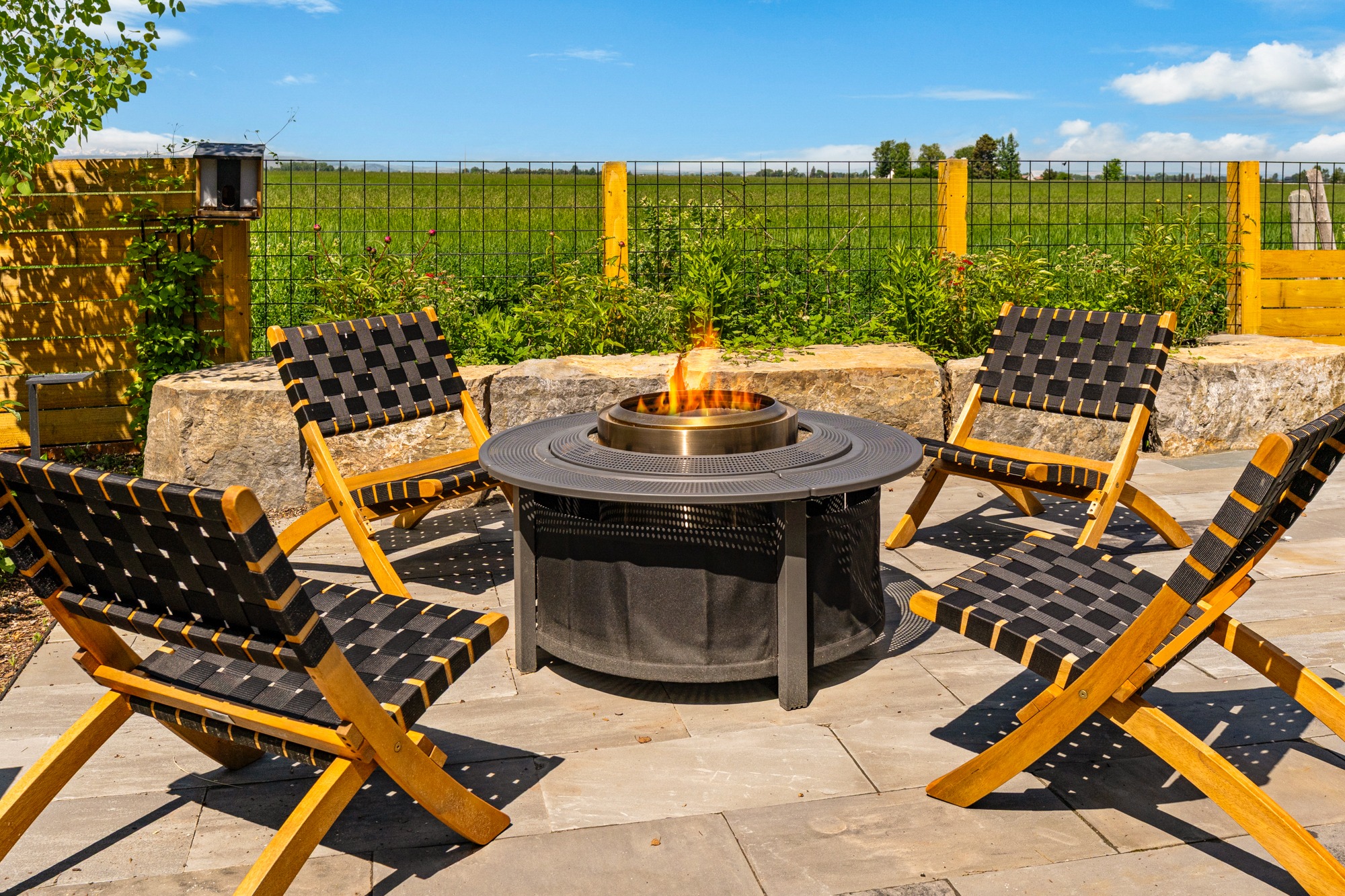 Outdoor patio with fire pit and lounge chairs