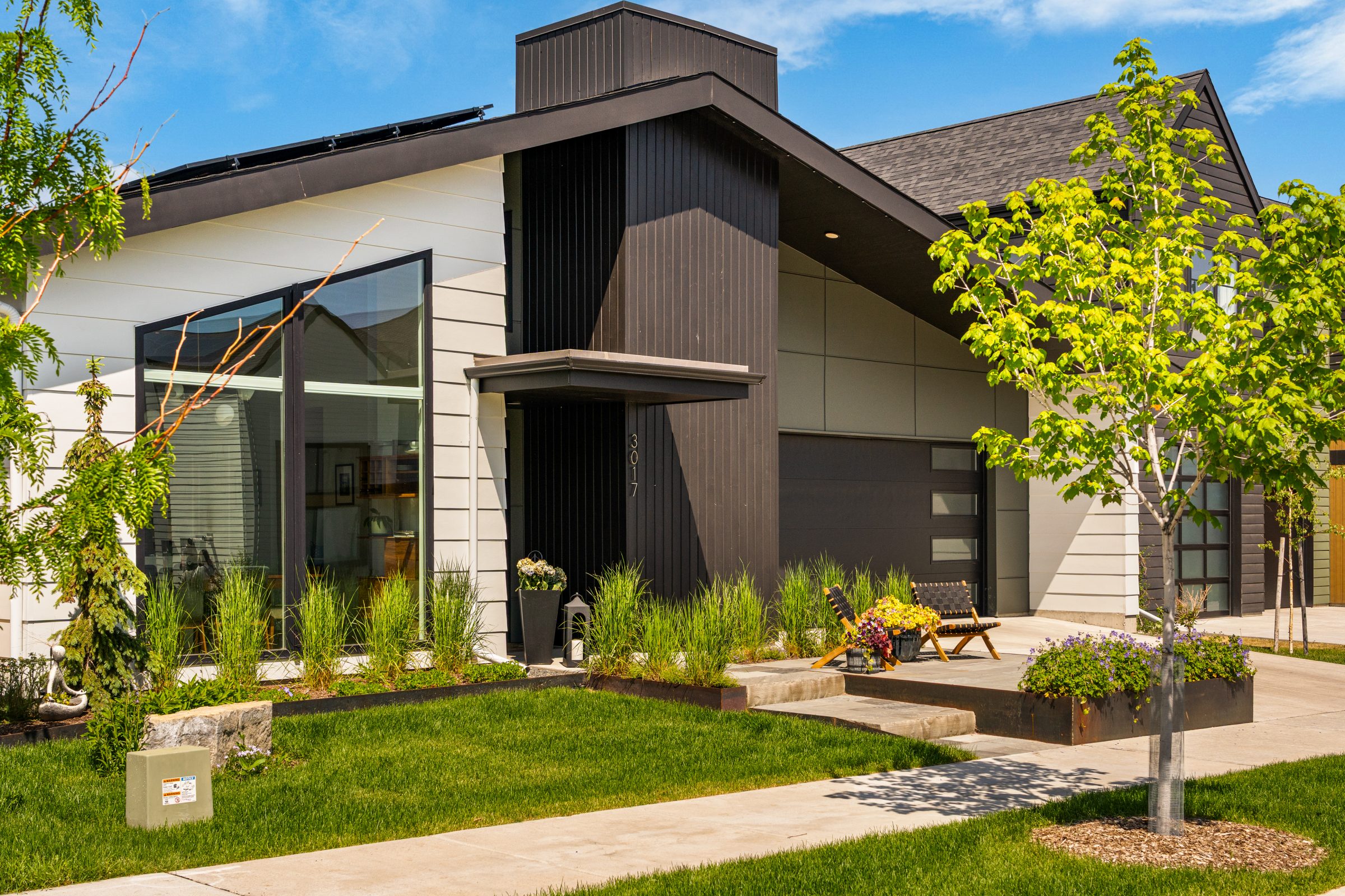 Modern house with large windows and landscaped yard