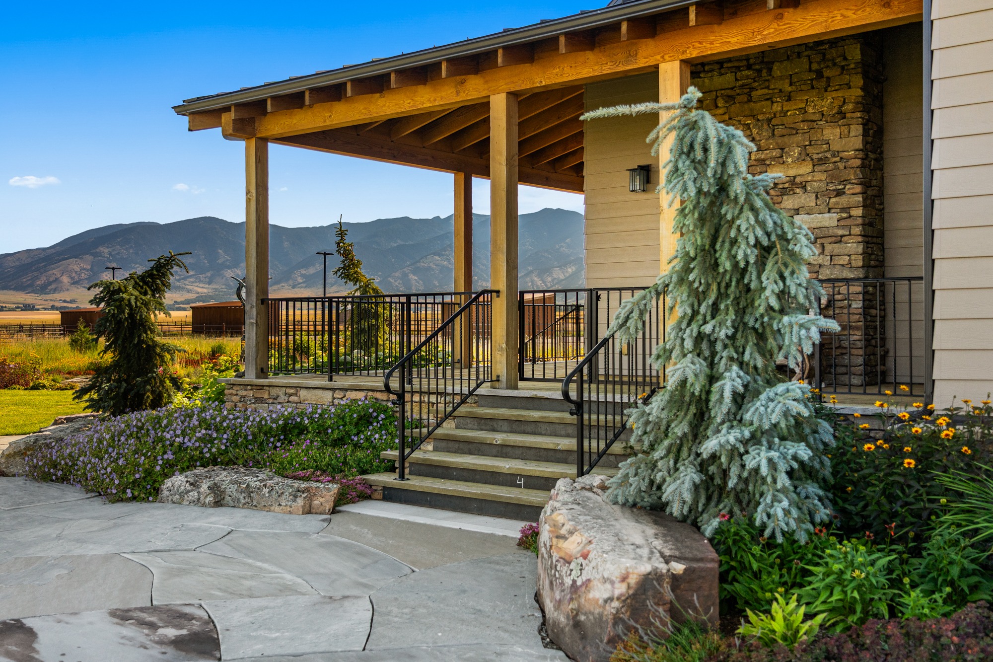 Rustic porch with mountain view and landscaped garden