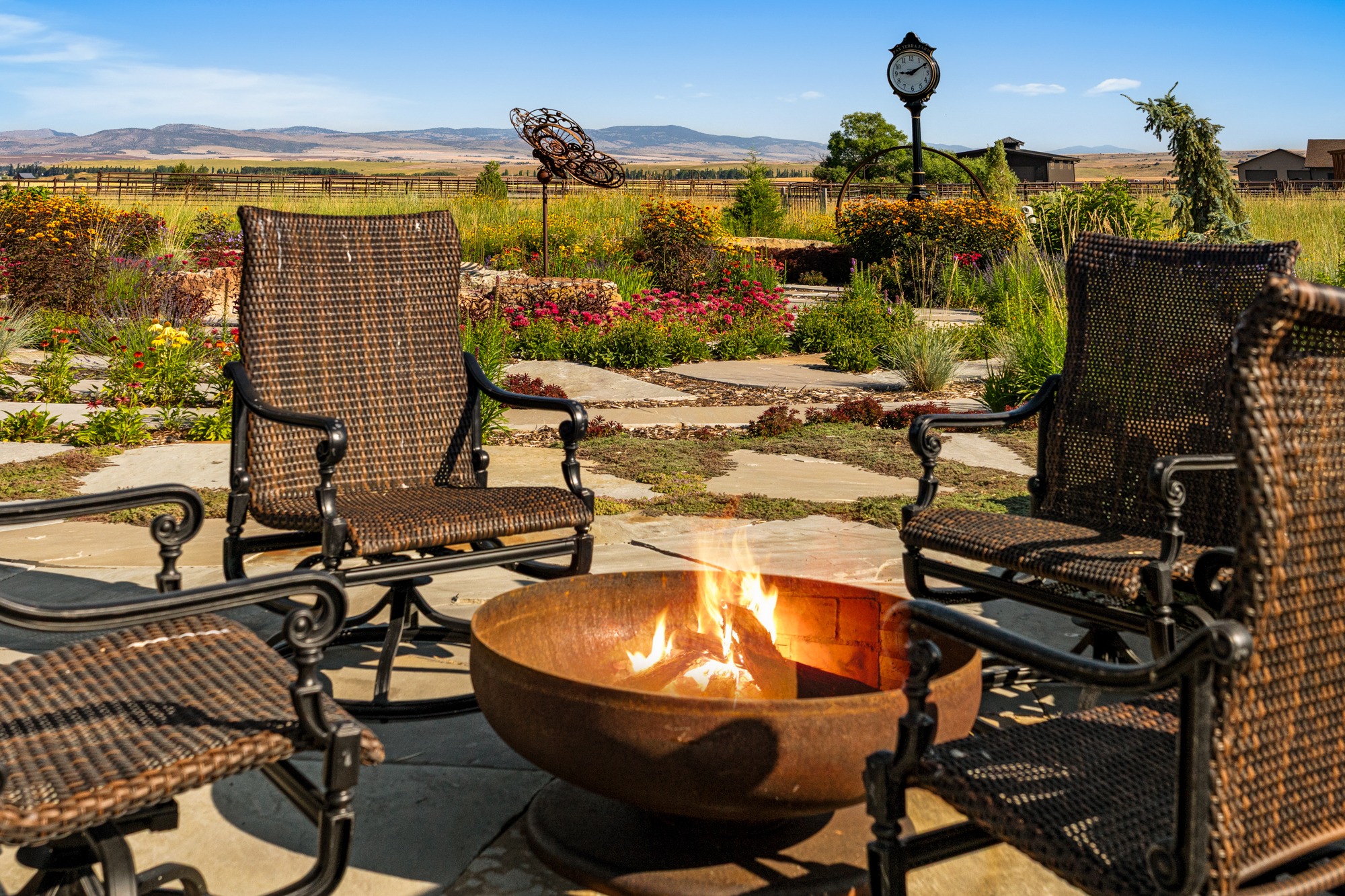 Wicker chairs around fire pit in garden patio