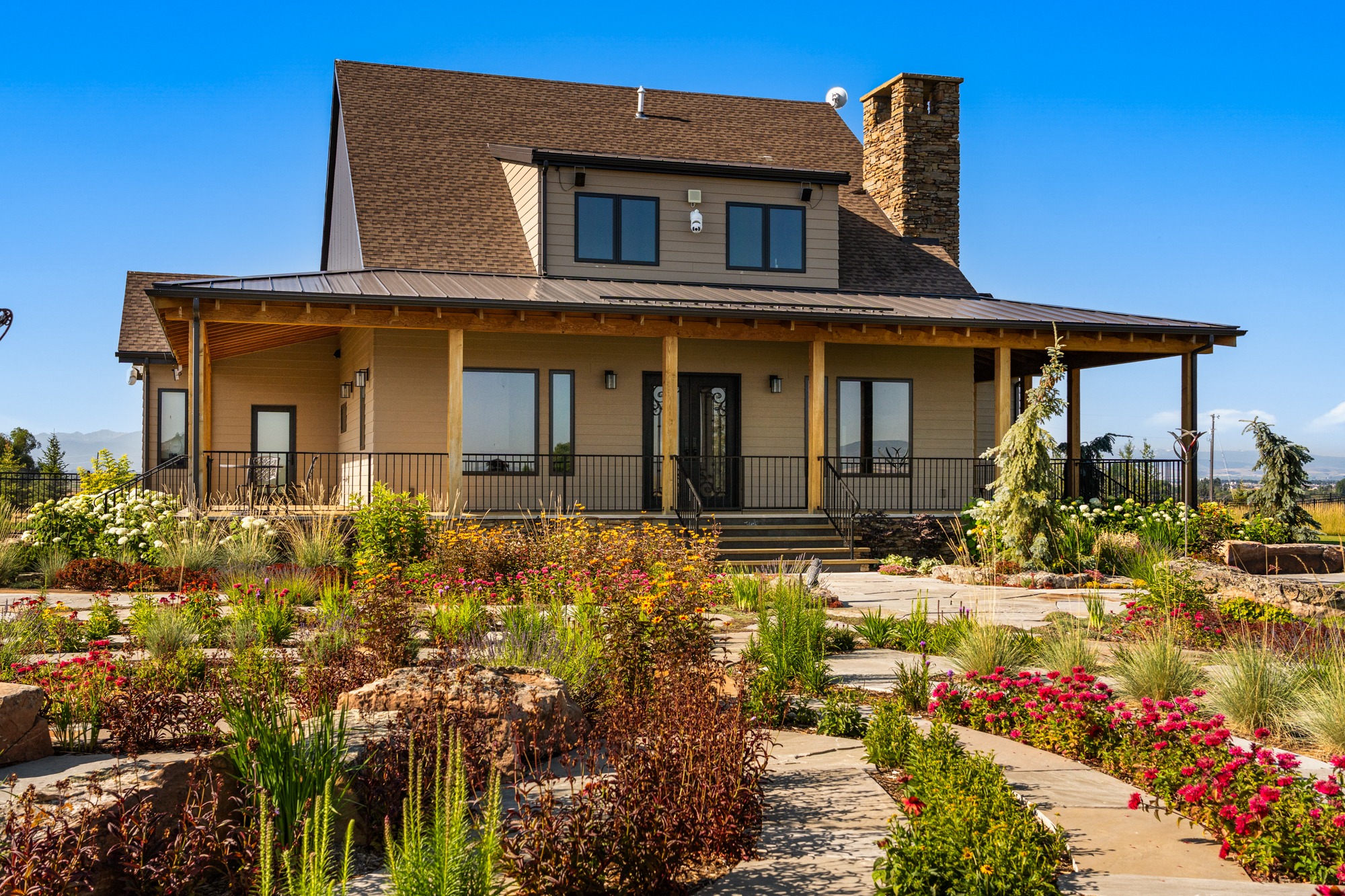 Modern farmhouse with wraparound porch and garden
