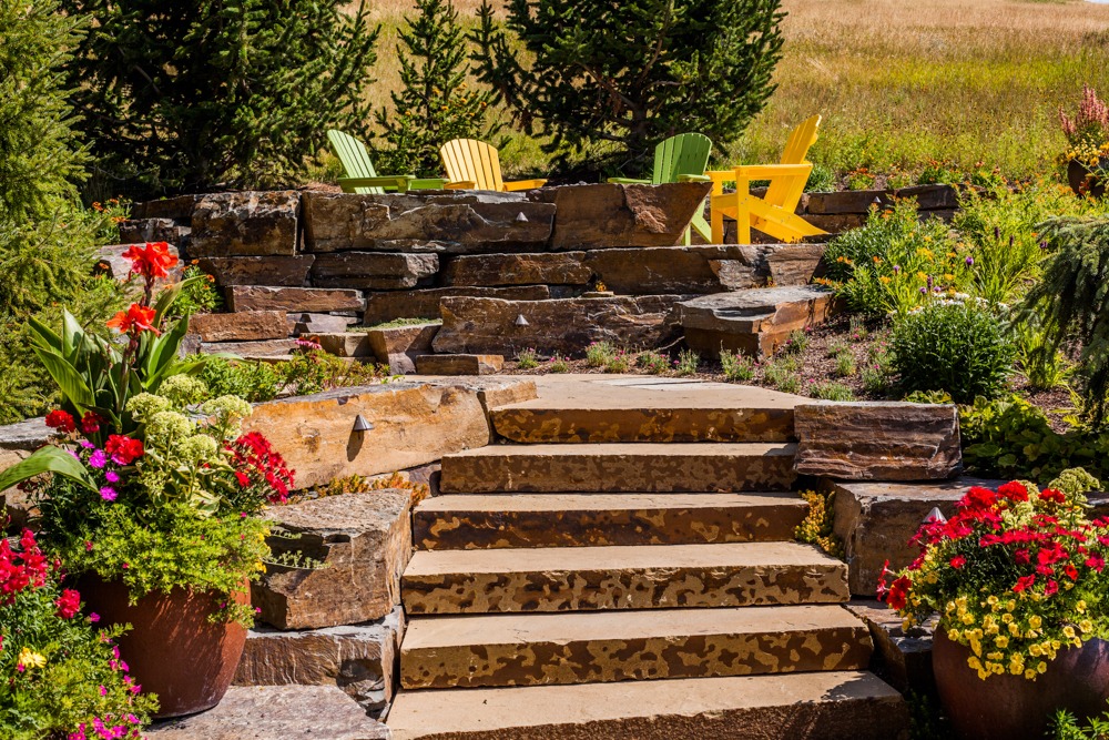 Stone steps leading to garden patio with chairs