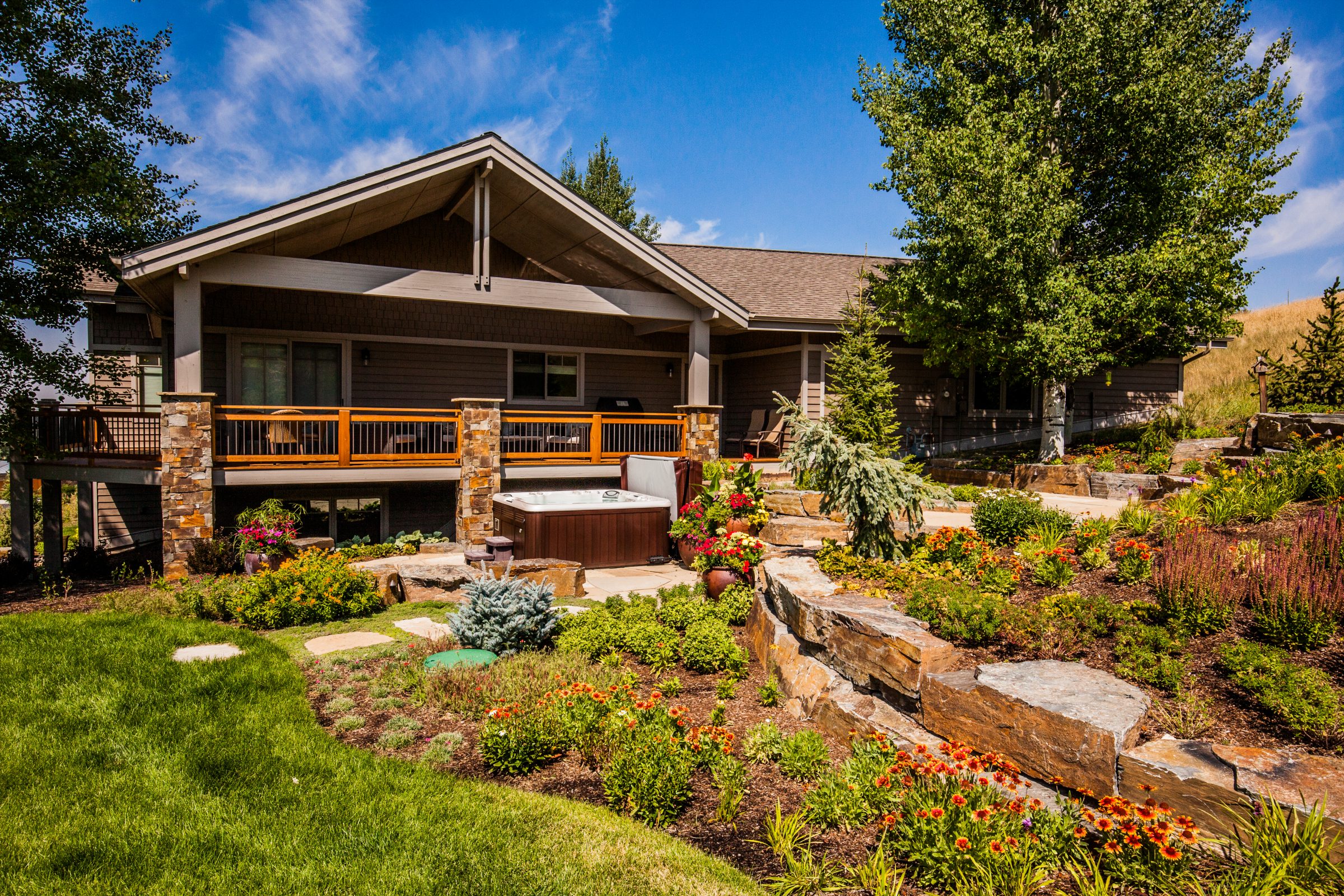 Craftsman home with landscaped garden and hot tub
