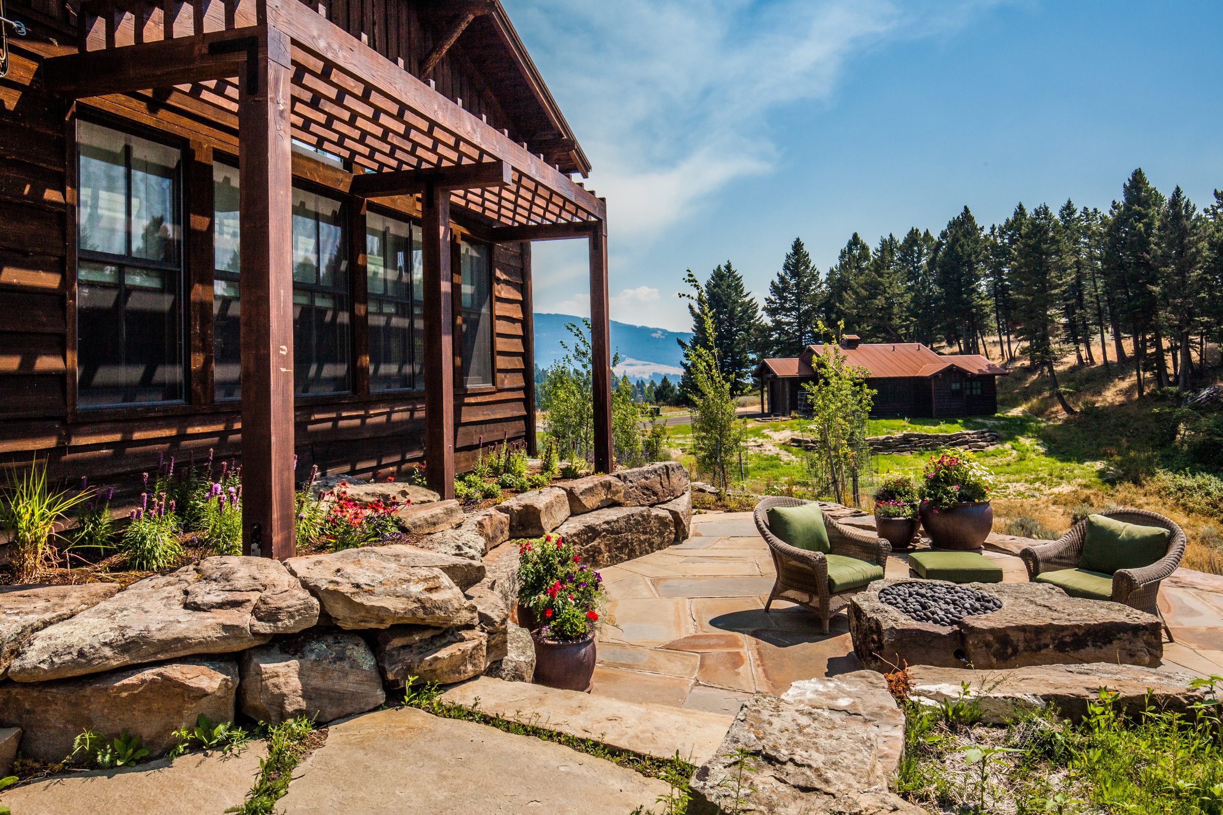 Rustic cabin with stone patio and mountain view