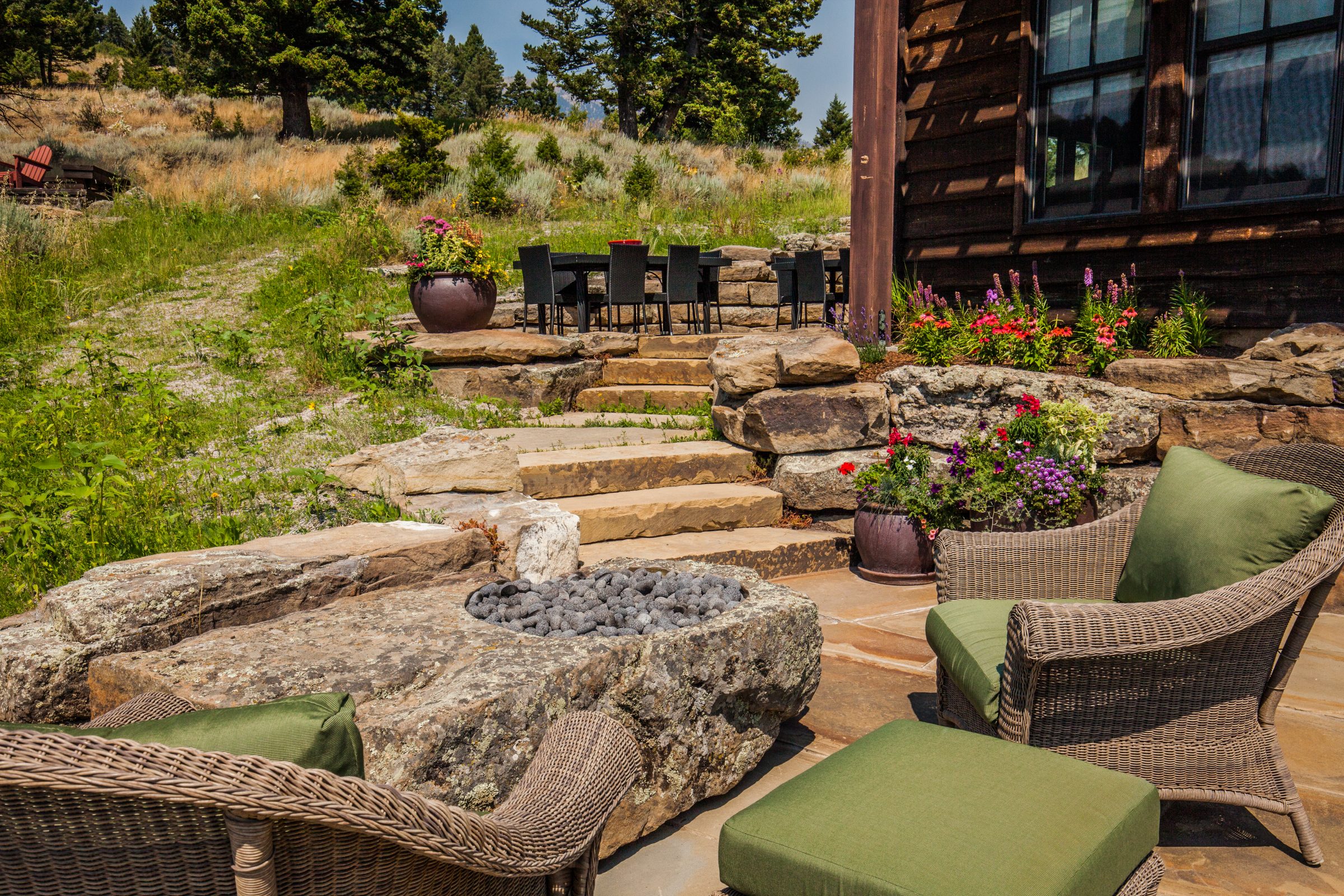 Rustic patio with stone fire pit and seating