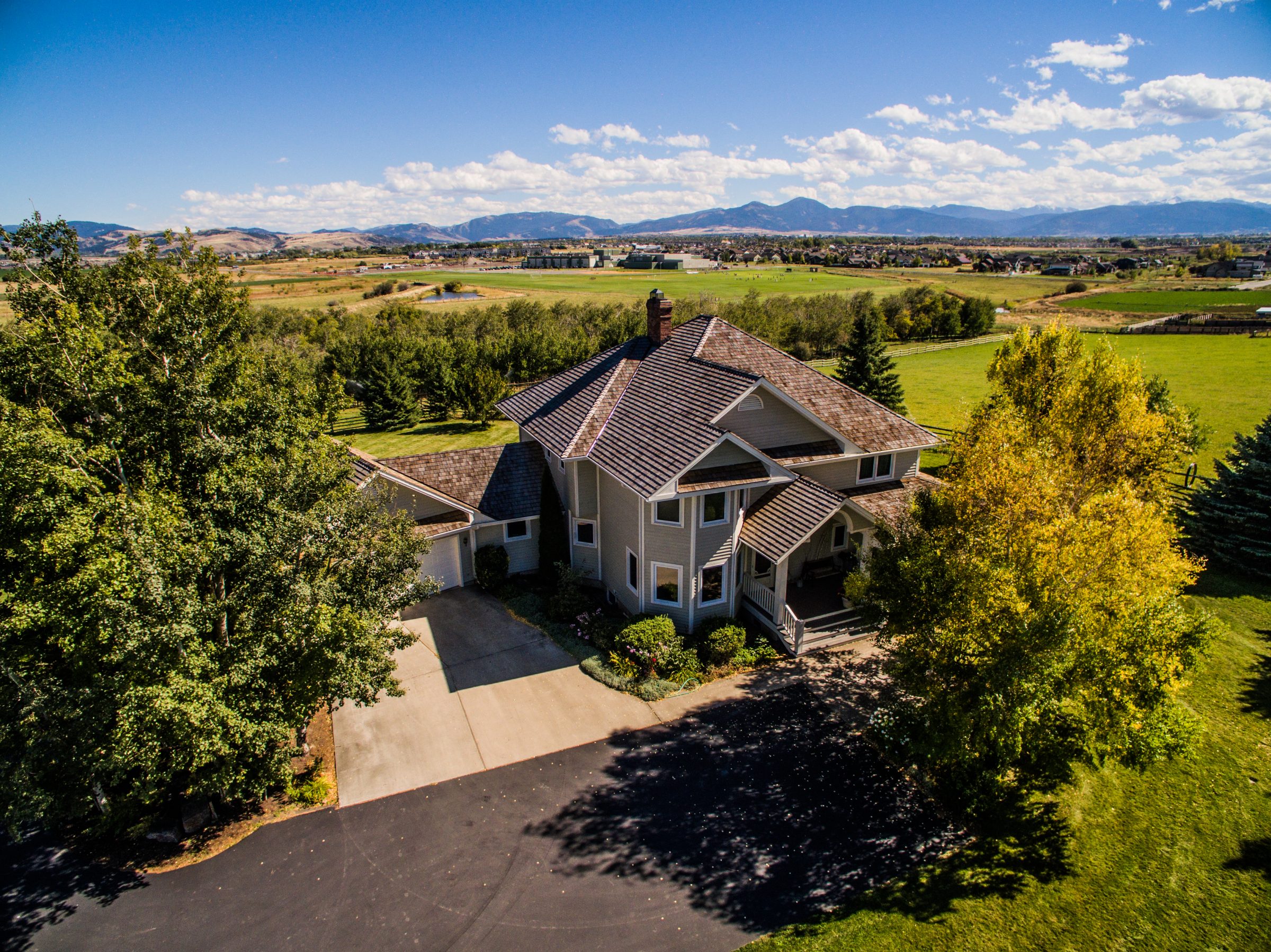 Aerial view of suburban home with mountain backdrop