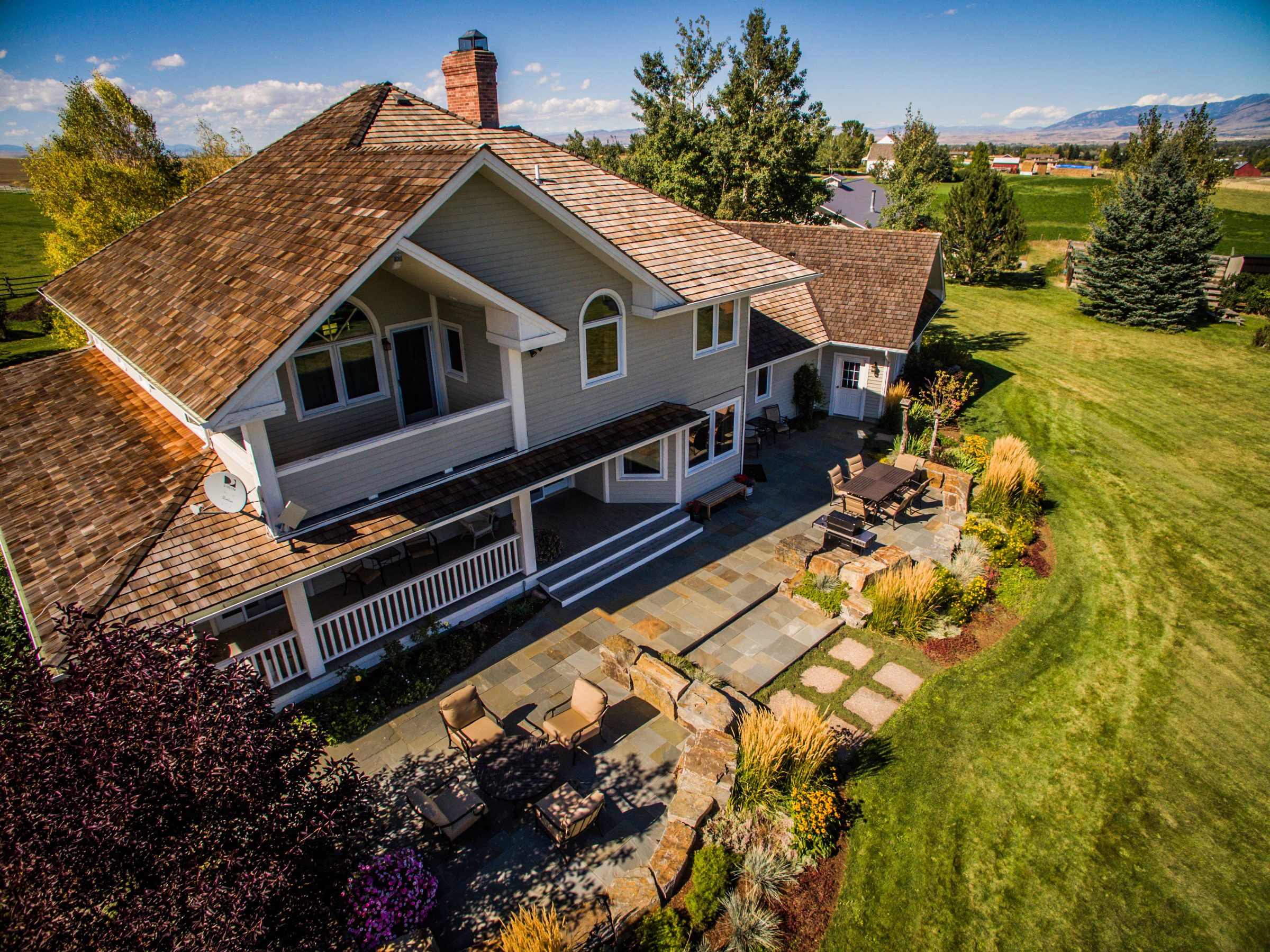 Large suburban home with landscaped backyard patio
