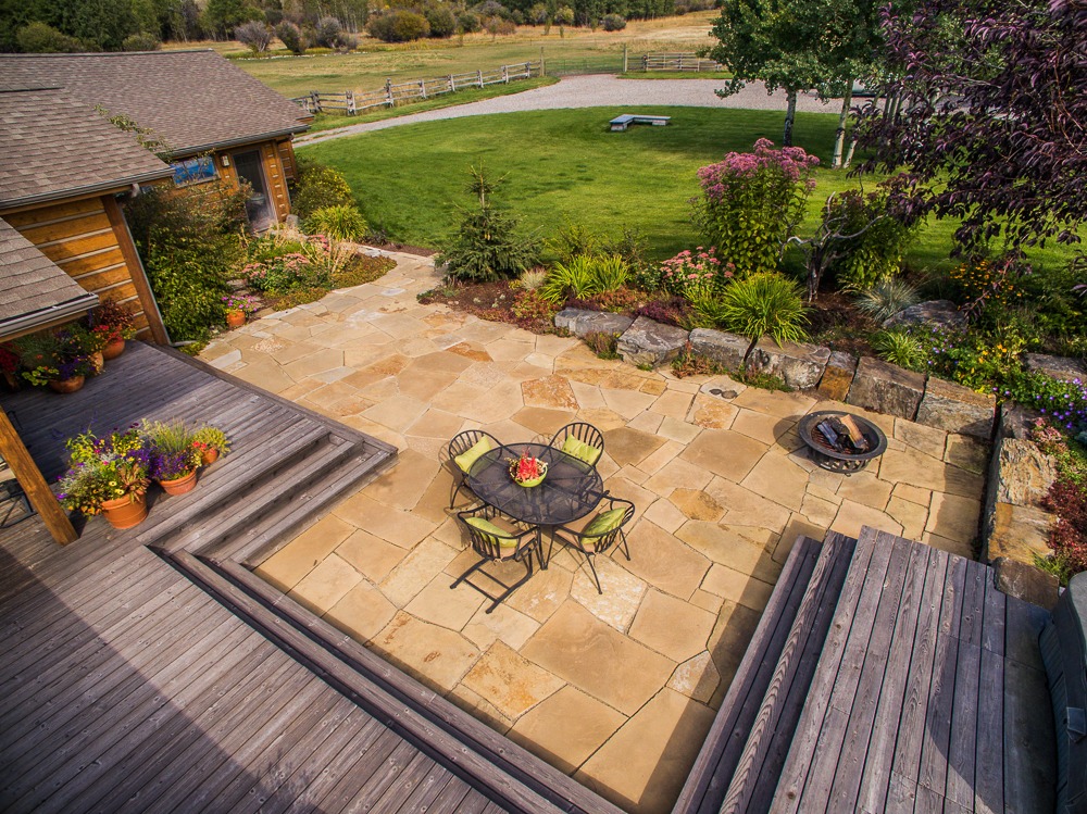 Stone patio with outdoor dining set and fire pit