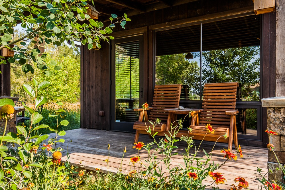 Wooden porch with chairs and wildflowers