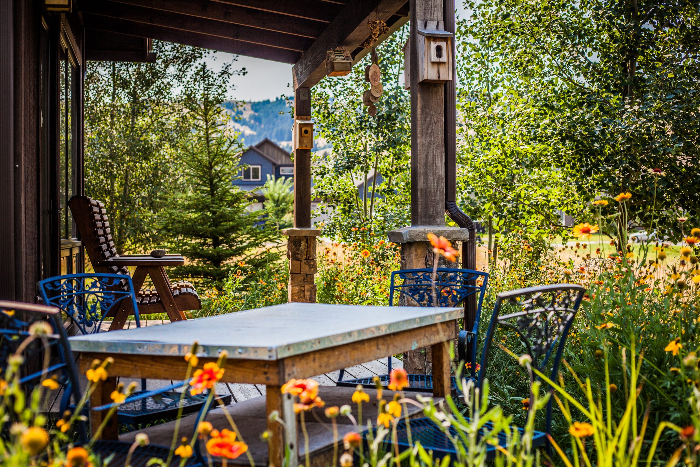 Cozy porch with garden flowers and outdoor table