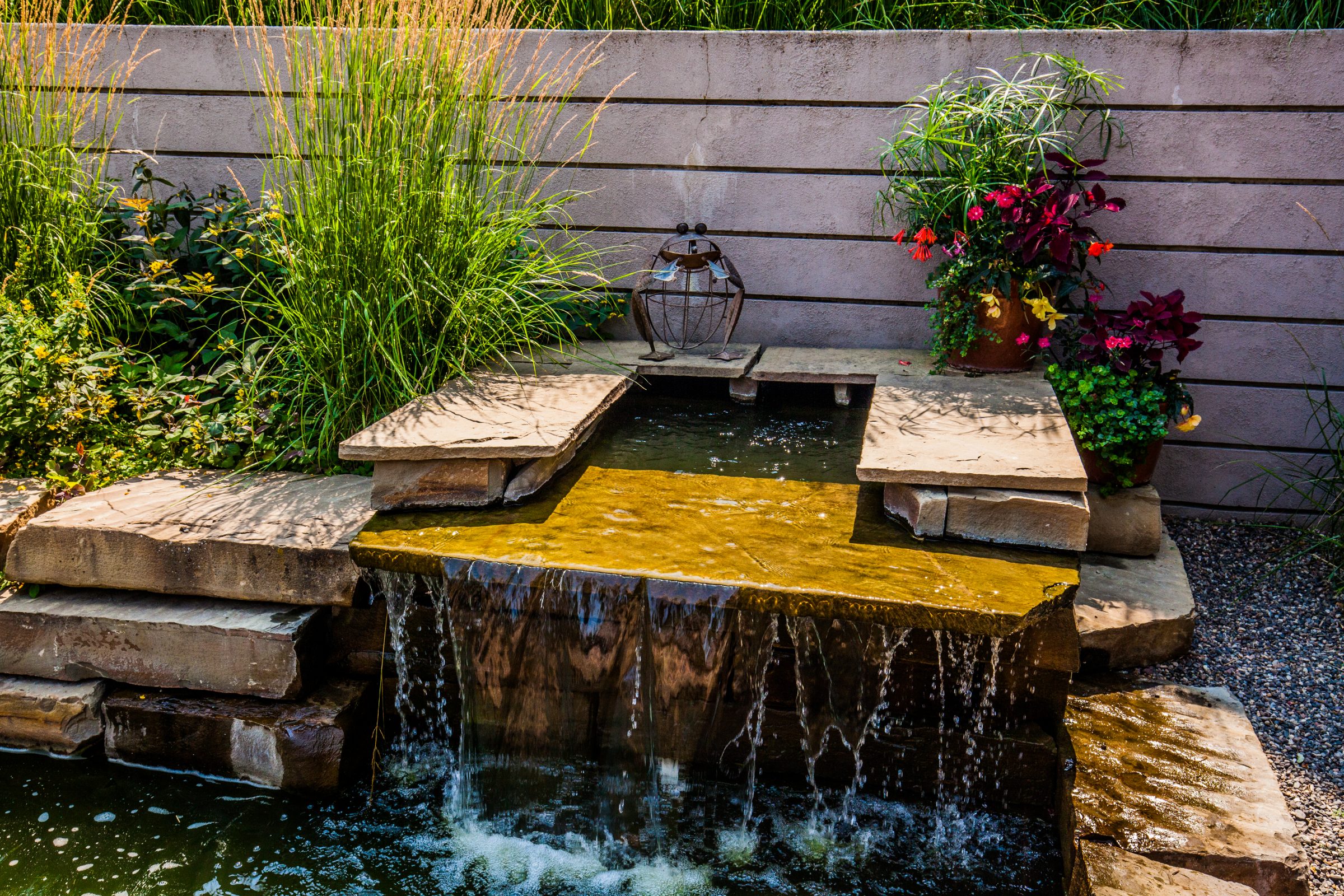 Stone garden waterfall with pond and plants