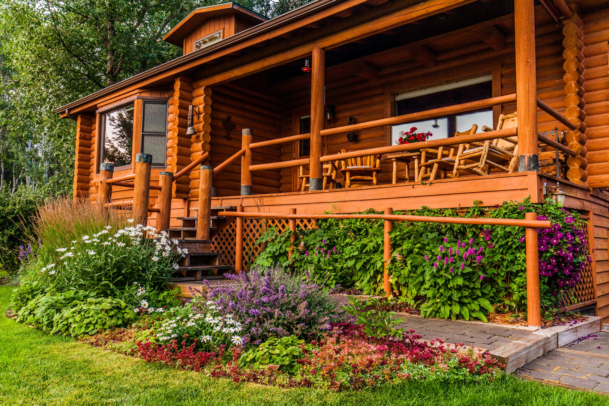 Rustic log cabin with porch and garden