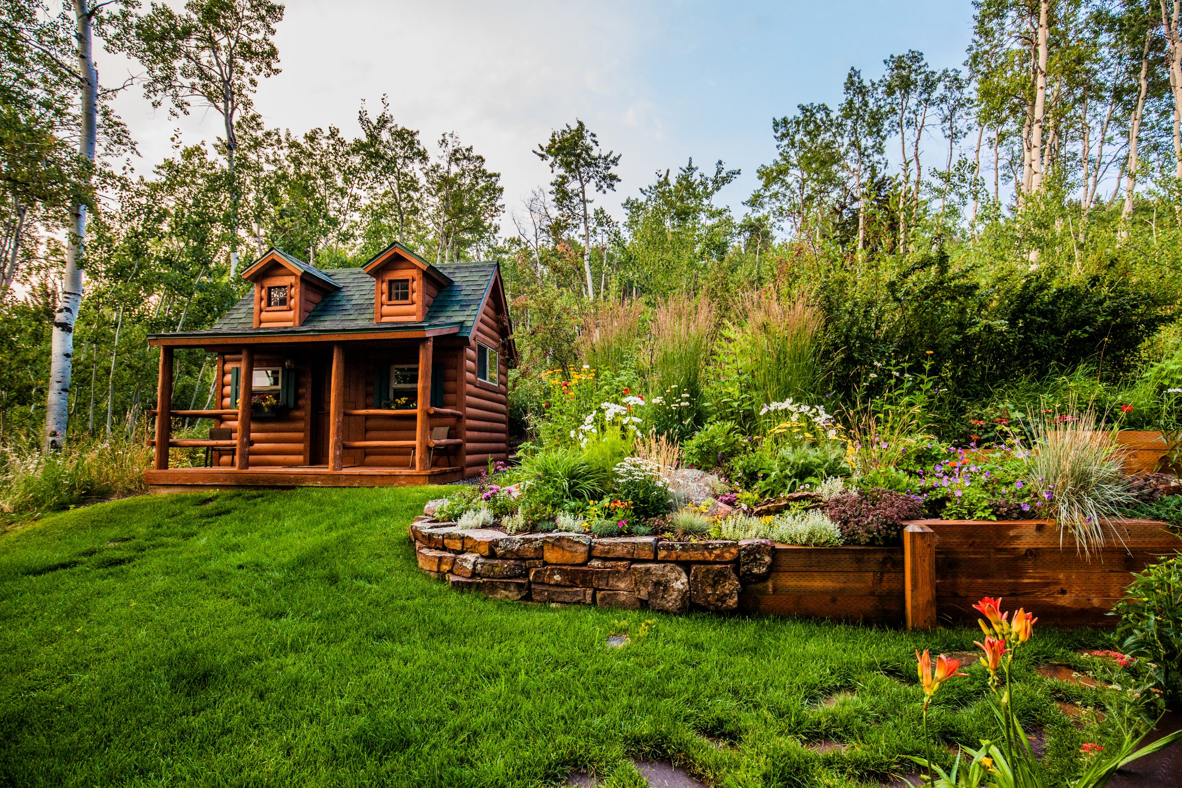 Small log cabin in lush garden setting