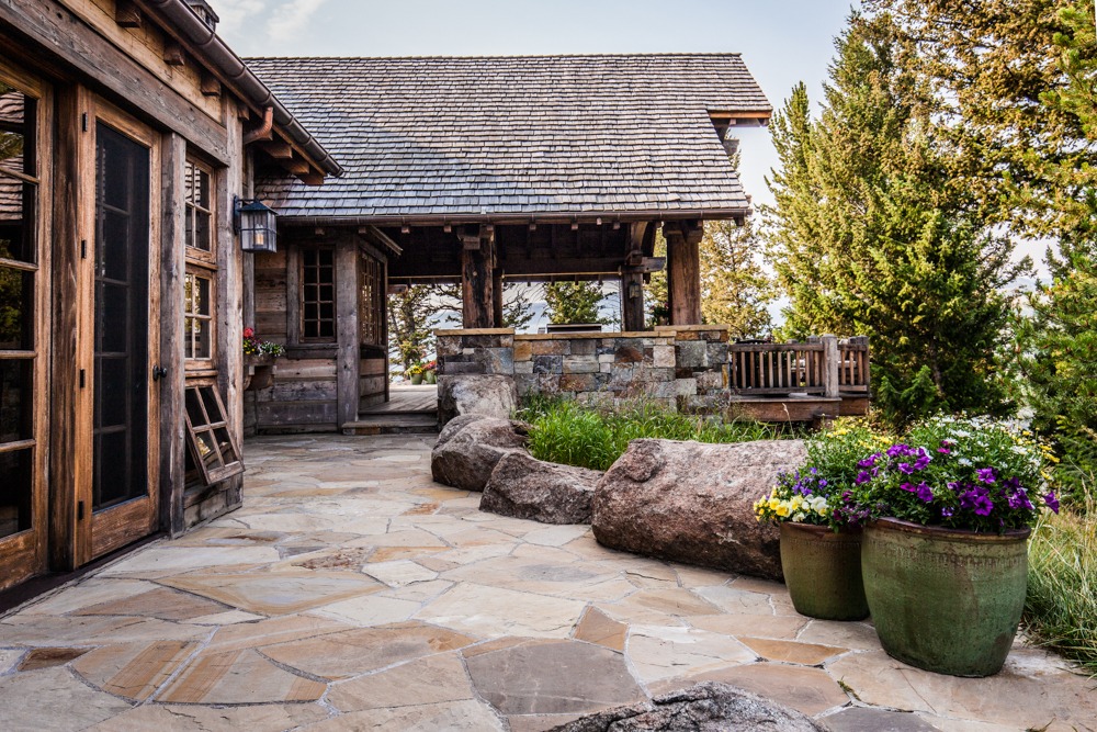 Rustic wooden cabin patio with stone walkway