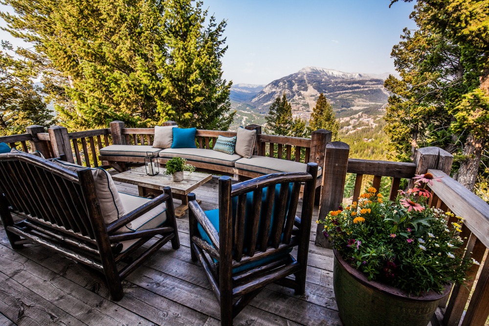 Rustic mountain deck with seating and scenic view