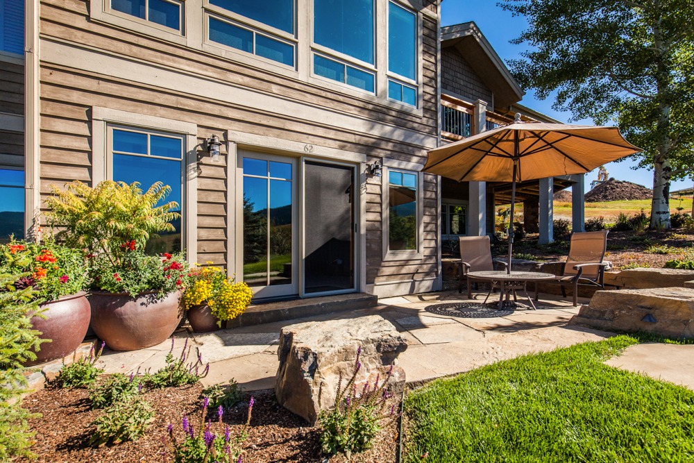 Backyard patio with umbrella and garden landscaping