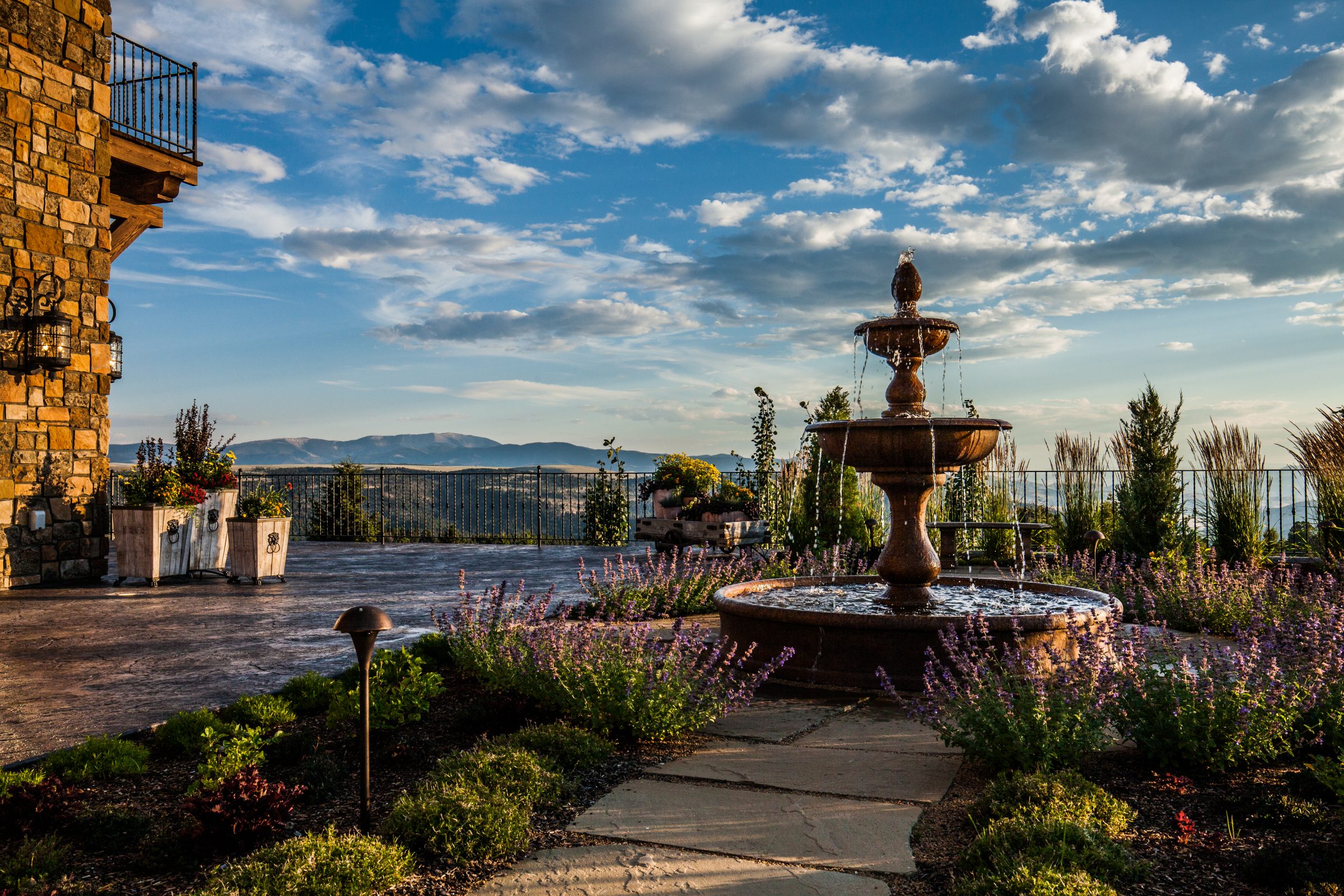 Stone patio fountain overlooking mountains at sunset