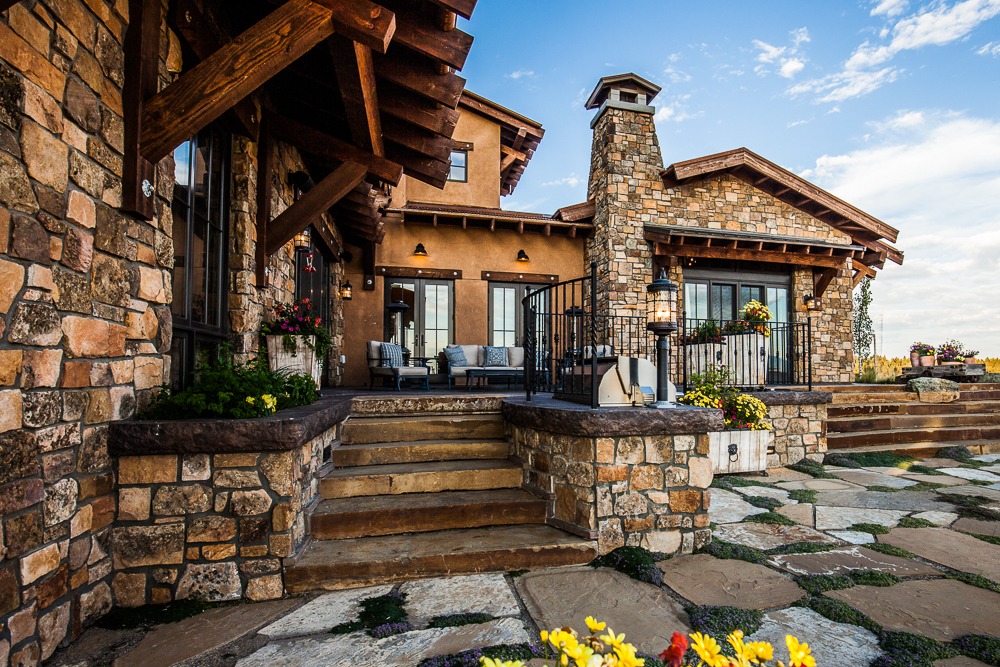 Rustic stone house with patio and steps