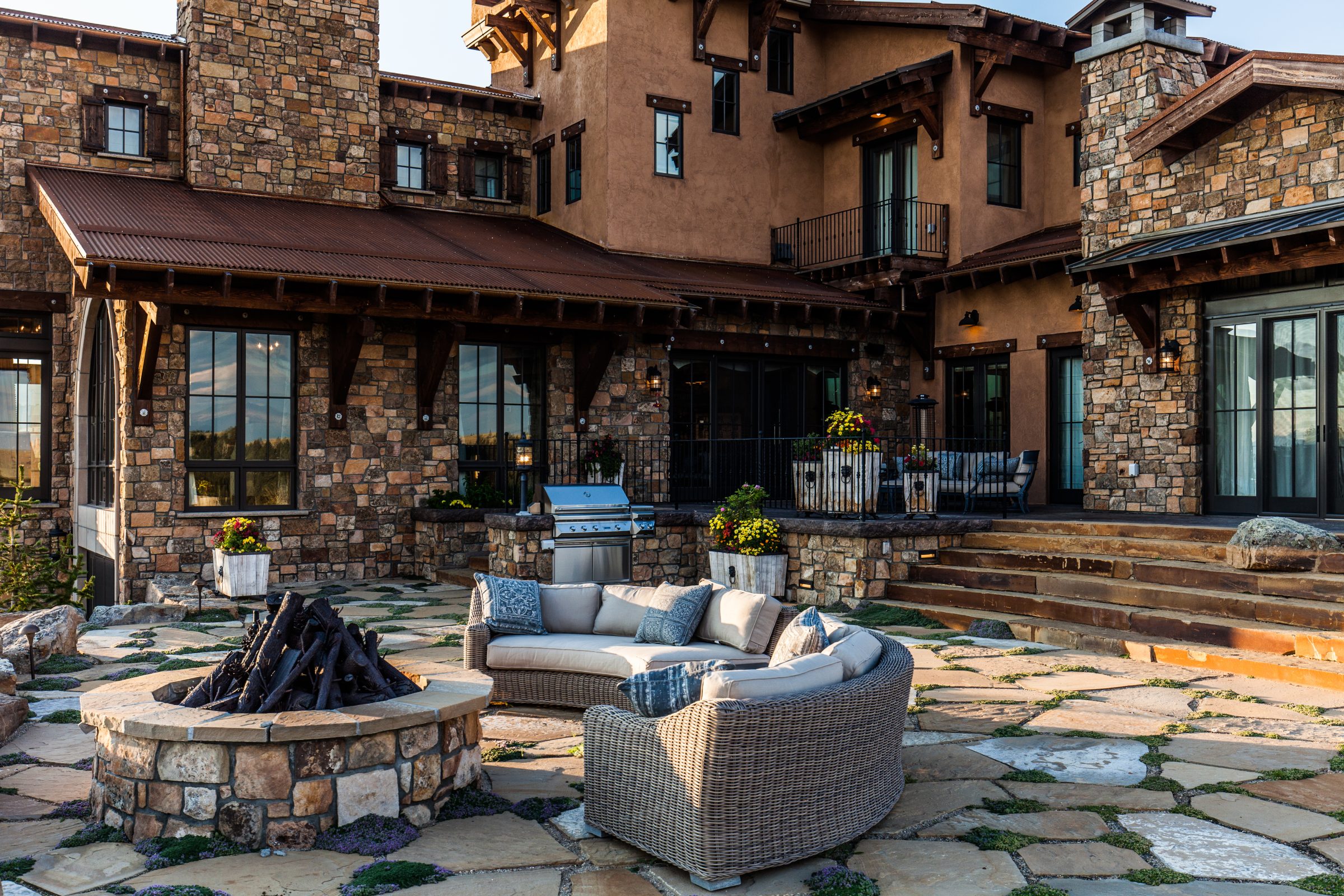 Luxury stone home with patio and fire pit