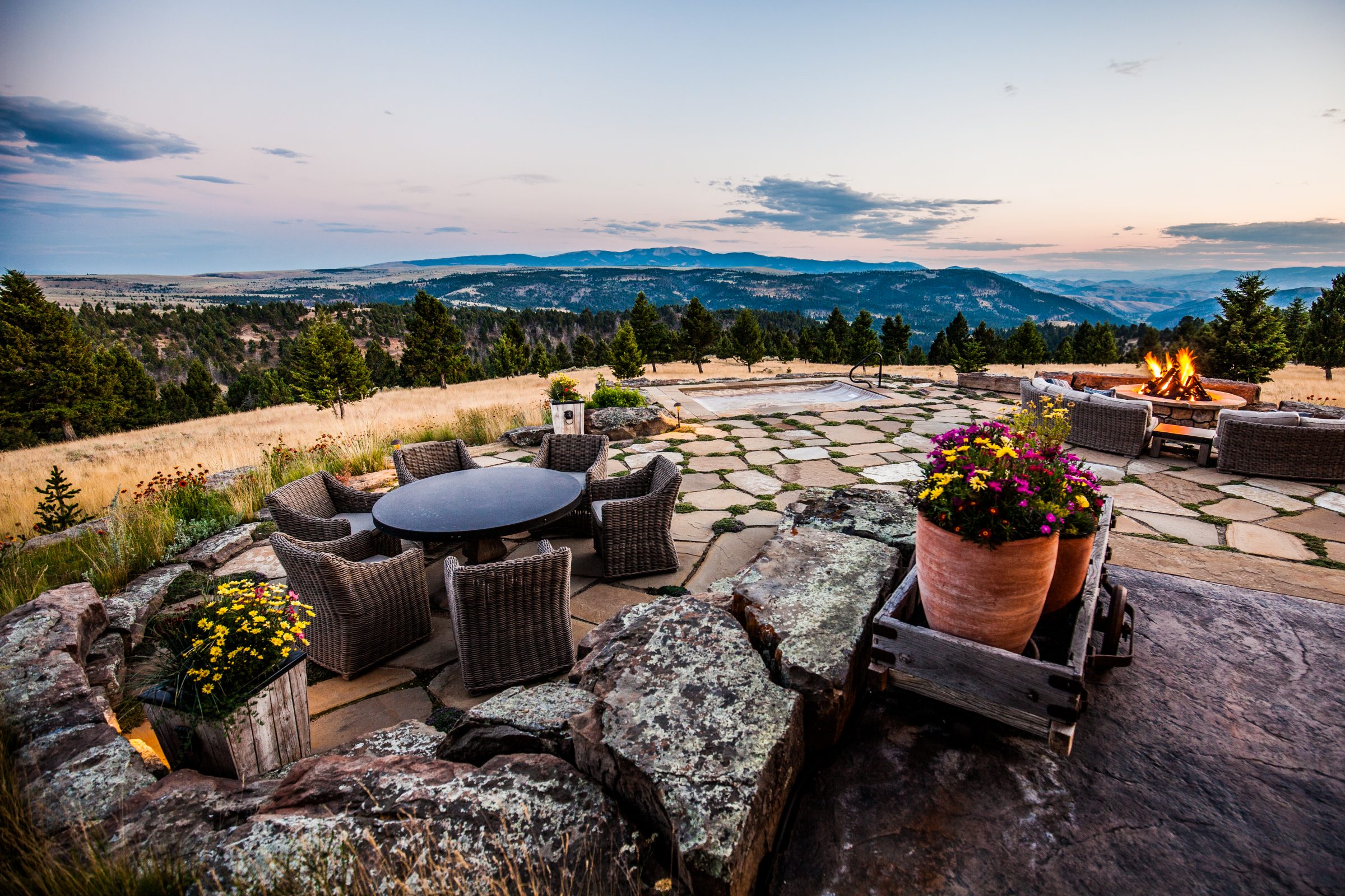 Mountain patio with fire pit at sunset