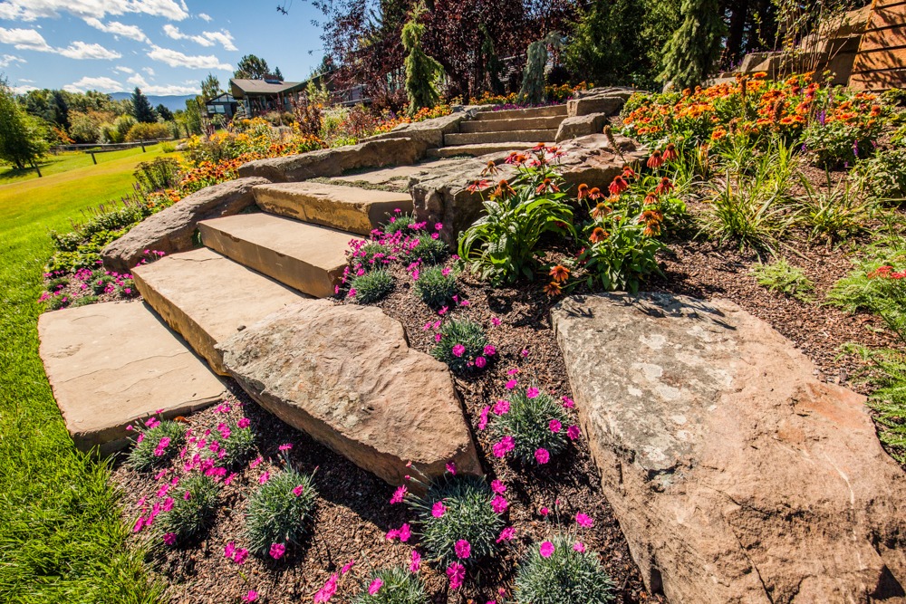 Stone garden steps surrounded by colorful flowers