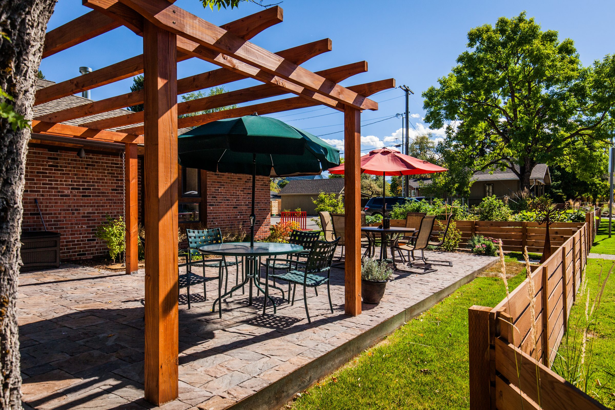 Backyard patio with wooden pergola and outdoor seating