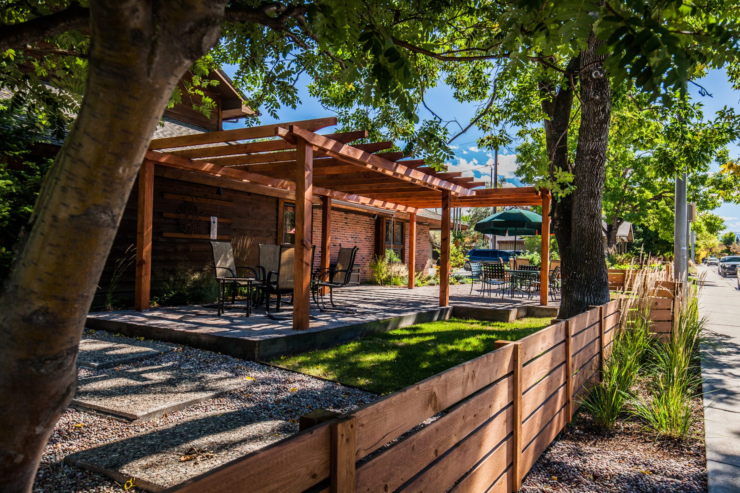 Backyard patio with wooden pergola and outdoor seating