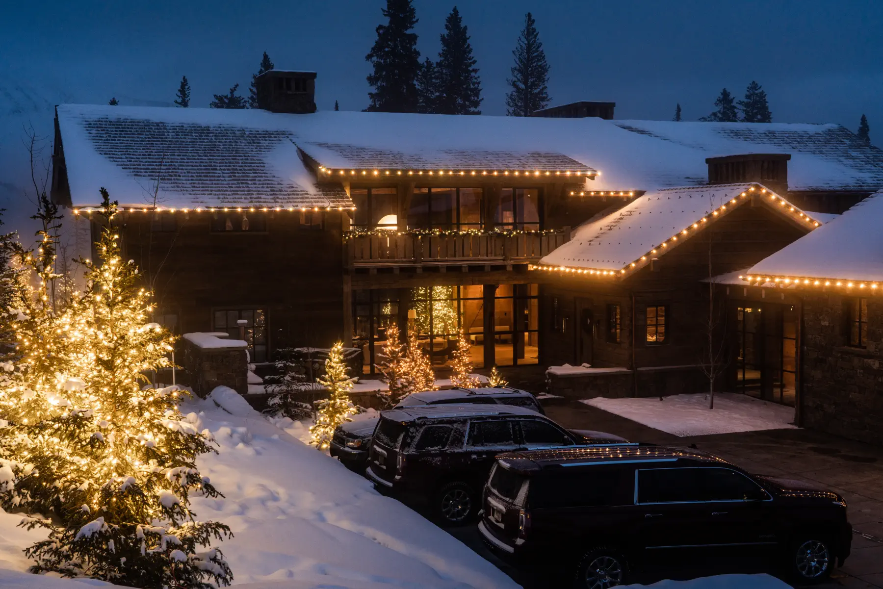 Snowy lodge decorated with warm holiday lights
