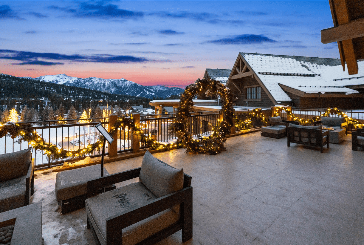 Snowy mountain resort terrace with holiday lights
