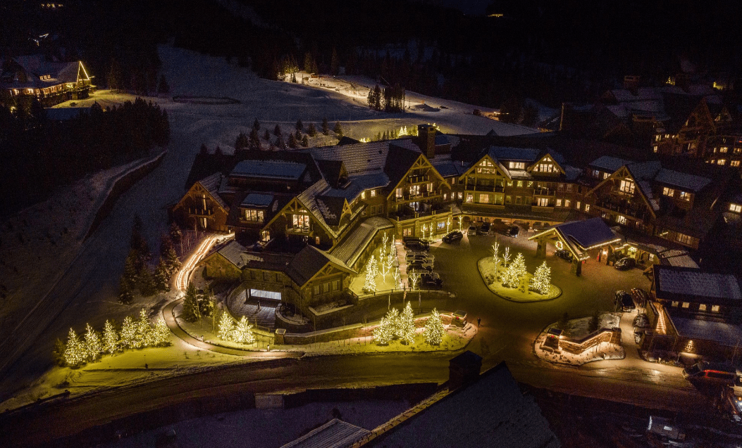 Snowy mountain lodge illuminated at night