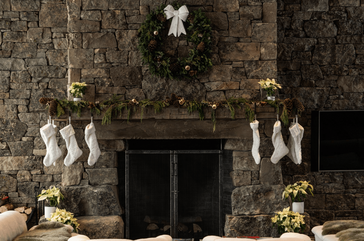 Christmas stockings on rustic stone fireplace mantel